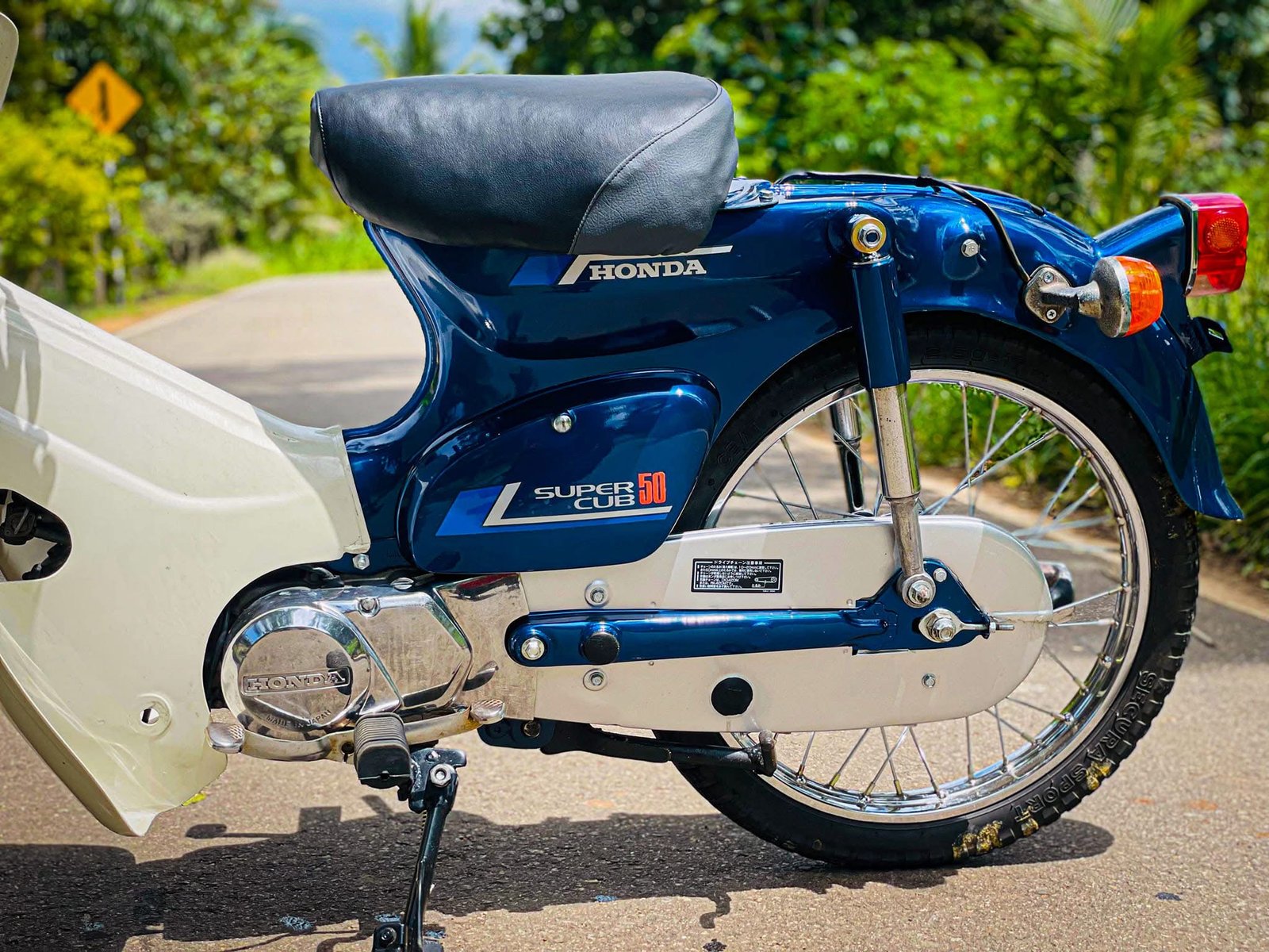 Close view of blue Honda Super Cub restoration