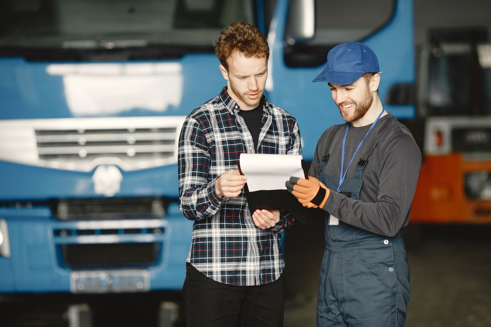 Mechanic and customer reviewing a written repair plan and quotation
