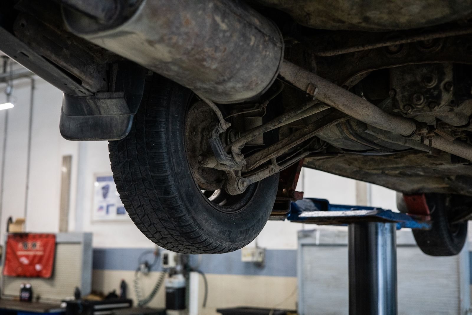 Vehicle undercarriage raised for cleaning and protective undercoat treatment